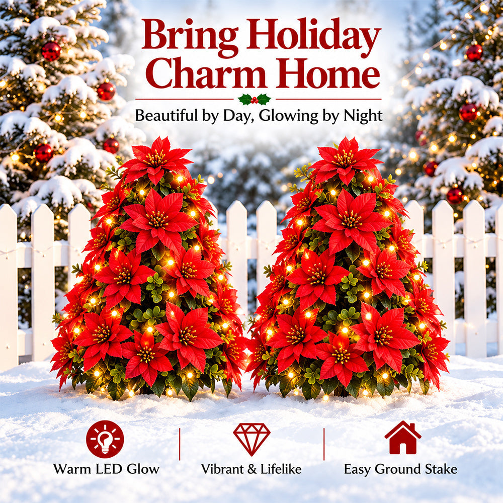 Lighted red poinsettia tree stakes in a Christmas garden display