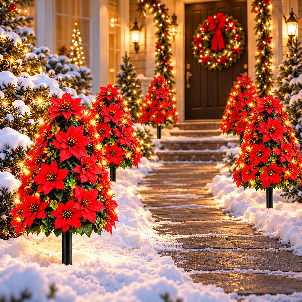 Poinsettia tree stakes arranged beside a festive entrance path